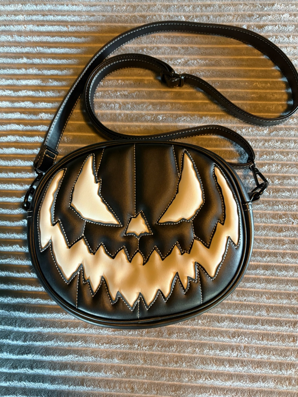 Love, Pain, and Stitches Black & Cream Jack-O'-Lantern Round Crossbody Bag